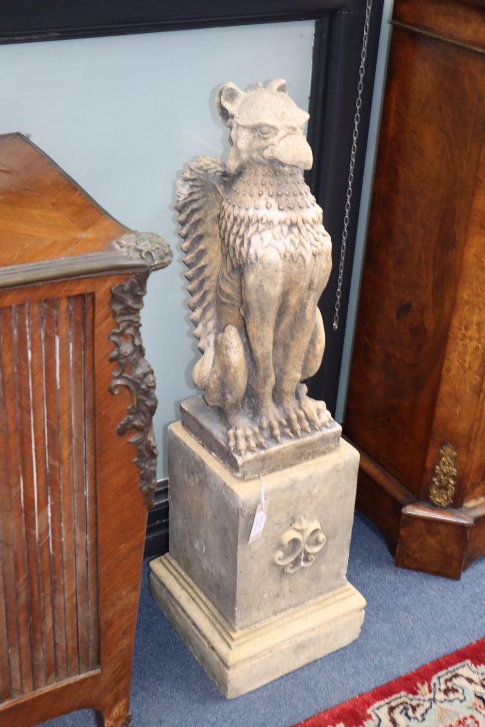 A pair of composition griffins and pedestals, H.94cm